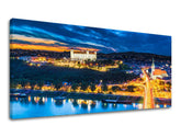 Klasický obraz na plátne s motívom PANORÁMA SLOVENSKO, hrad, rieka, most, západ slnka v modro-oranžových odtieňoch, pokojná atmosféra, vhodný do kancelárie – hlavný